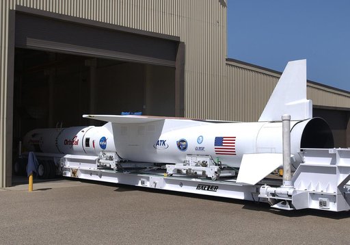 The mated Pegasus XL rocket - AIM spacecraft leaves Building 165