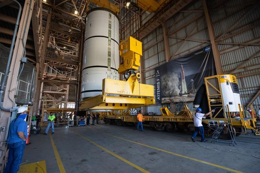Artemis I Booster Segments Lift to Work Stand and Silhouettes