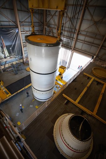 Artemis I Booster Segments Lift to Work Stand and Silhouettes
