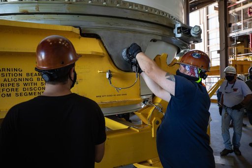 Artemis I Booster Segments Lift to Work Stand and Silhouettes