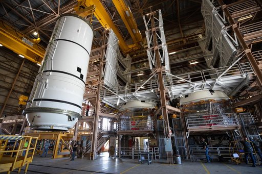 Artemis I Booster Segments Lift to Work Stand and Silhouettes