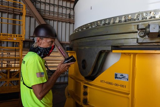 Artemis I Booster Segments Lift to Work Stand and Silhouettes