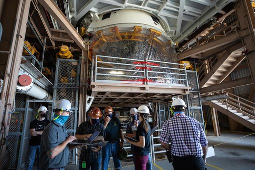 Artemis I Booster Segments Lift to Work Stand and Silhouettes