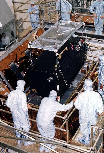 KENNEDY SPACE CENTER, FLA. - Workers in KSC's Vertical Processing Facility lower the Near Infrared Camera and Multi-Object Spectrometer (NICMOS) into the Second Axial Carrier.  NICMOS is one of two new scientific instruments that will replace two outdated instruments on the Hubble Space Telescope (H