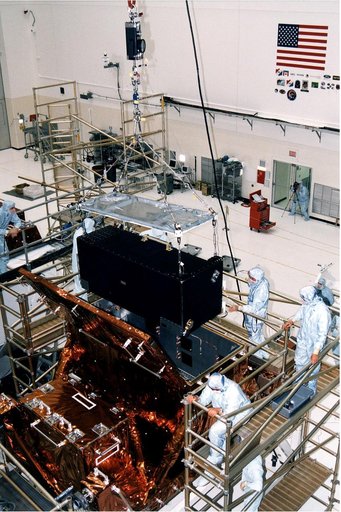 KENNEDY SPACE CENTER, FLA. -  Workers in KSC's Vertical Processing Facility lower the Near Infrared Camera and Multi-Object Spectrometer (NICMOS) into the Second Axial Carrier.  NICMOS is one of two new scientific instruments that will replace two outdated instruments on the Hubble Space Telescope (