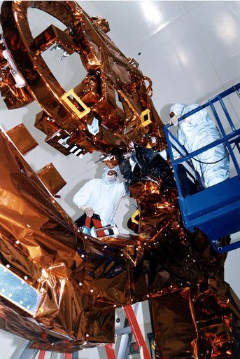 KENNEDY SPACE CENTER, FLA. -  Workers in KSC's Vertical Processing Facility make final adjustments to the Flight Support System (FSS) for STS-82, the second Hubble Space Telescope servicing mission.  The FSS is reusable flight hardware that provides the mechanical, structural and electrical interfac