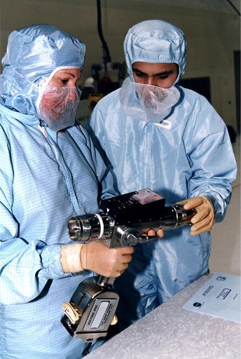 KENNEDY SPACE CENTER, FLA. -  In KSC's Vertical Processing Facility, Louise Kleba of the Vehicle Integration Test Team (VITT) and engineer Devin Tailor of Goddard Space Flight Center examine the Pistol Grip Tool (PGT), which was designed for use by astronauts during spacewalks.  The PGT is a self-co