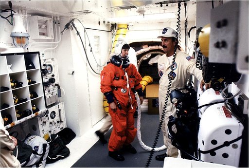 KENNEDY SPACE CENTER, FLA. - STS-83 Payload Commander Janice E. Voss prepares to enter the Space Shuttle Columbia at Launch Pad 39A after getting assistance from the White Room closeout crew that included Bob Saulnier (right).