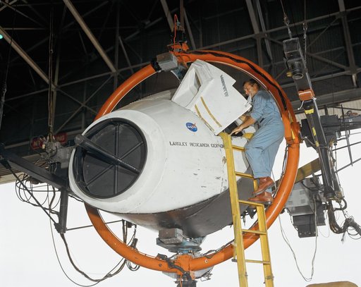 Astronaut Richard F. Gordon Jr. Climbing in to Training Simulator