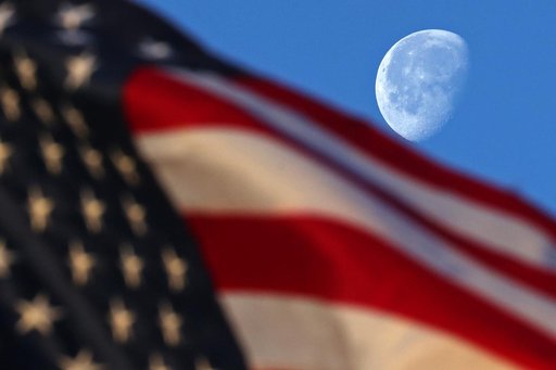 Waning Gibbous Moon sets behind flag at MAF
