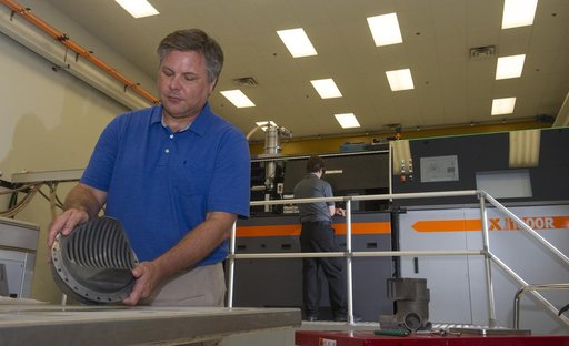 Andy Hardin with 3-D printed engine part