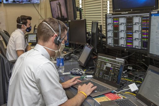 Stewart Whaley, Cameron Muelling, foreground, and teams at NASA’s Marshall Space Flight Center help monitor launch conditions for the Demo-2 mission from the Huntsville Operations Support Center, HOSC.