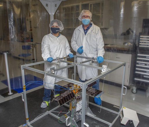 Spacecraft in Gravity Off-load Fixture (GOLF), System Test configuration - Arisa Waddle – Test Engineer,  Rick Wilson – Lead Test Engineer