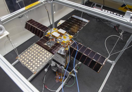 Spacecraft in Gravity Off-load Fixture (GOLF), System Test configuration - Arisa Waddle – Test Engineer,  Rick Wilson – Lead Test Engineer