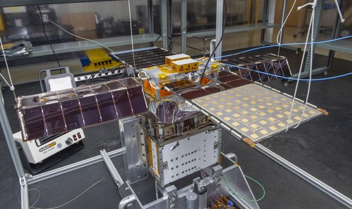 Spacecraft in Gravity Off-load Fixture (GOLF), System Test configuration - Arisa Waddle – Test Engineer,  Rick Wilson – Lead Test Engineer