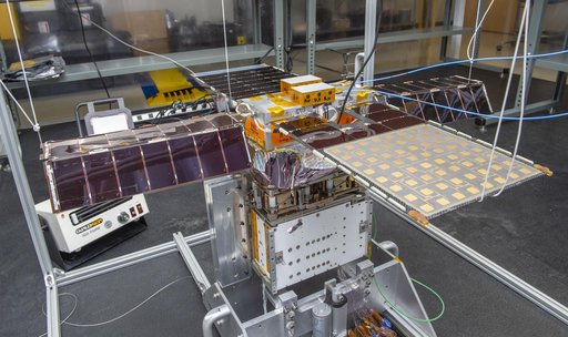 Spacecraft in Gravity Off-load Fixture (GOLF), System Test configuration - Arisa Waddle – Test Engineer,  Rick Wilson – Lead Test Engineer
