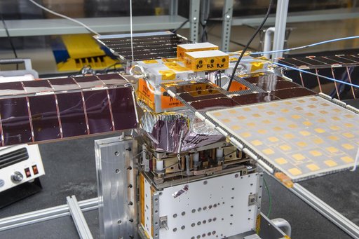 Spacecraft in Gravity Off-load Fixture (GOLF), System Test configuration - Arisa Waddle – Test Engineer,  Rick Wilson – Lead Test Engineer