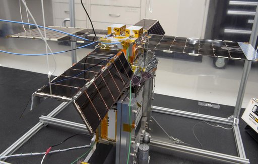 Spacecraft in Gravity Off-load Fixture (GOLF), System Test configuration - Arisa Waddle – Test Engineer,  Rick Wilson – Lead Test Engineer