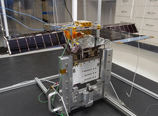 Spacecraft in Gravity Off-load Fixture (GOLF), System Test configuration - Arisa Waddle – Test Engineer,  Rick Wilson – Lead Test Engineer