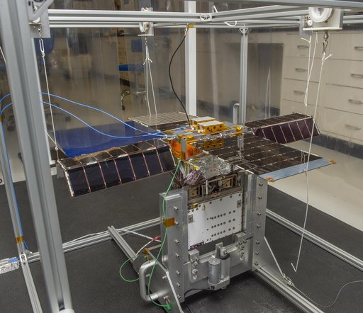 Spacecraft in Gravity Off-load Fixture (GOLF), System Test configuration - Arisa Waddle – Test Engineer,  Rick Wilson – Lead Test Engineer
