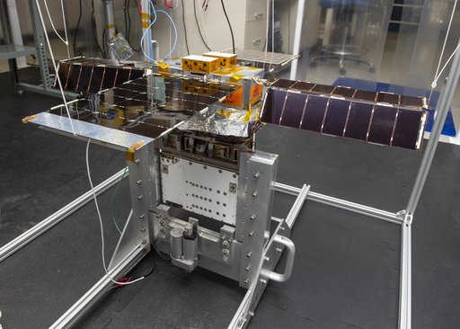 Spacecraft in Gravity Off-load Fixture (GOLF), System Test configuration - Arisa Waddle – Test Engineer,  Rick Wilson – Lead Test Engineer