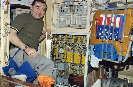 Strekalov performing maintenance on Core module control panel