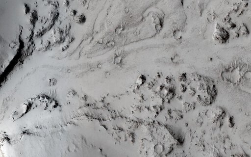 Breaching a Crater Rim in Tartarus Montes