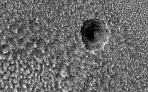 A Crater Enlarged by the Sublimation of Ice