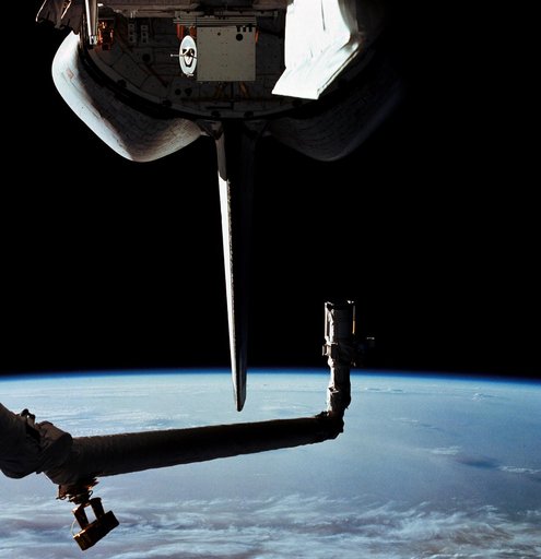 View of the Columbia's open payload bay and the Canadian RMS