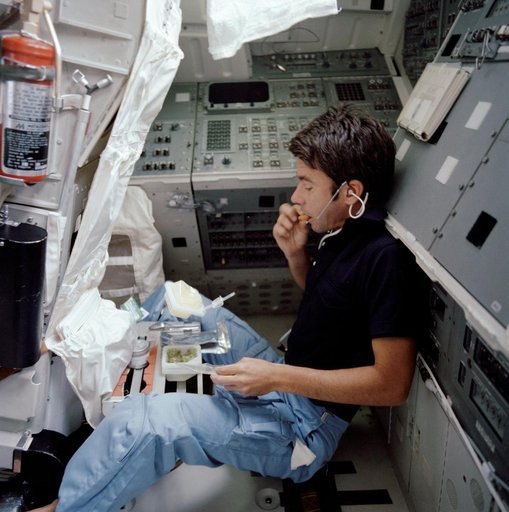 Mission specialist Lenoir takes break to eat his meal