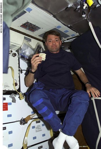 Pilot Ashby eats a meal on the middeck of Endeavour