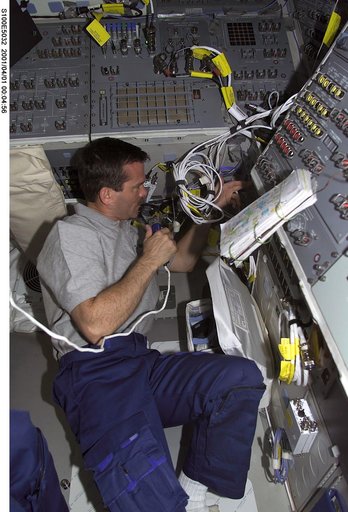 MS Hadfield checks rendezvous and communications gear on the aft flight deck of Endeavour