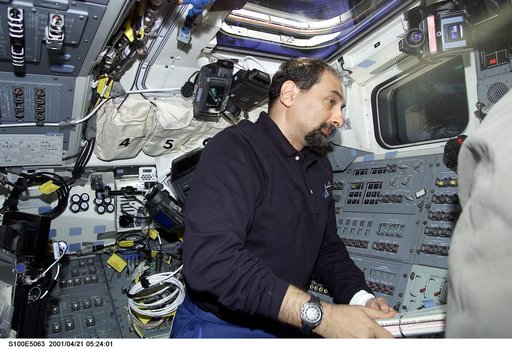 MS Guidoni works on the flight deck of Endeavour