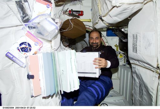 MS Guidoni looks over a checklist on the middeck of Endeavour
