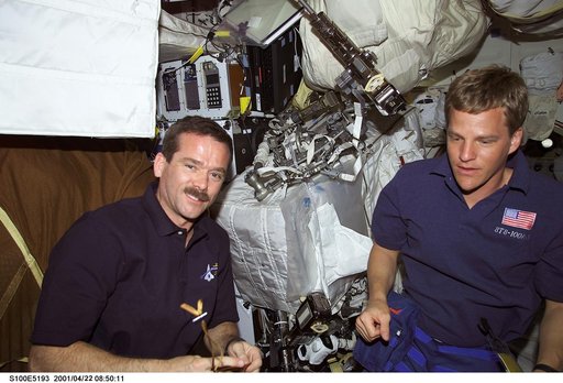 MS Hadfield and MS Parazynski go over EVA equipment on the middeck of Endeavour