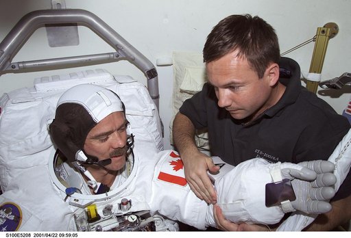 MS Lonchakov helps MS Hadfield with his EMU before the first EVA of STS-100
