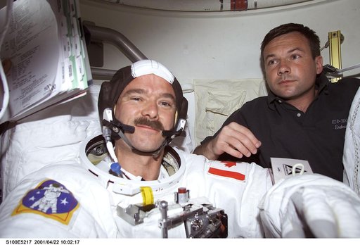 MS Lonchakov helps MS Hadfield with his EMU before the first EVA of STS-100