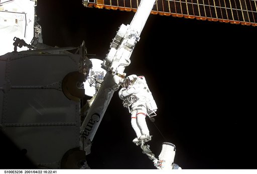 MS Hadfield works on the SSRMS in the SLP during the first EVA for STS-100