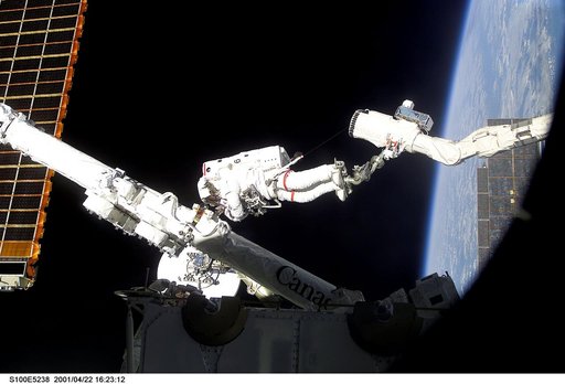 MS Hadfield works on the SSRMS in the SLP during the first EVA for STS-100