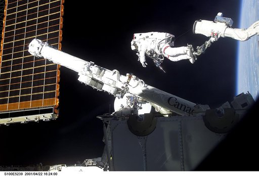 MS Hadfield works on the SSRMS in the SLP during the first EVA for STS-100