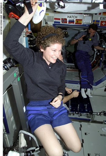 Expedition Two's Helms welcomes the STS-100 crew into the ISS