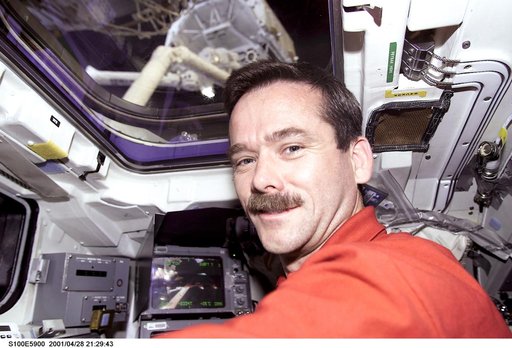 MS Hadfield works at the RMS controls on the flight deck of Endeavour during RMS handshake