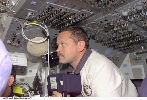 MS Morukov works on the aft flight deck of Atlantis during STS-106