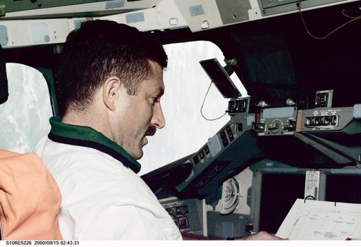MS Burbank works at the commander's workstation in Atlantis during STS-106