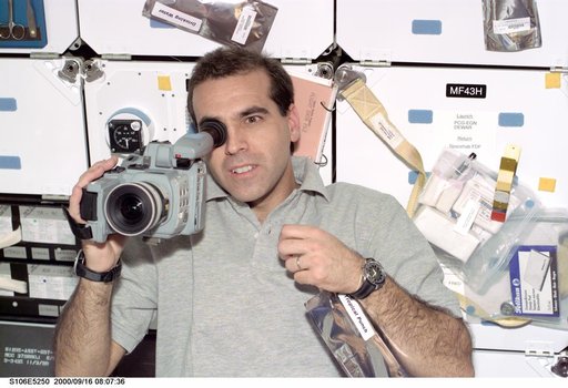 MS Mastracchio operates a camcorder on Atlantis during STS-106