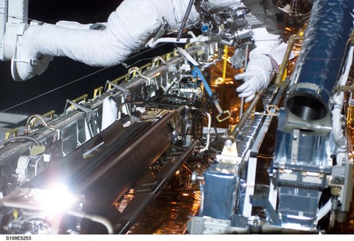 STS-109 MS Linnehan and Grunsfeld in payload bay during first EVA