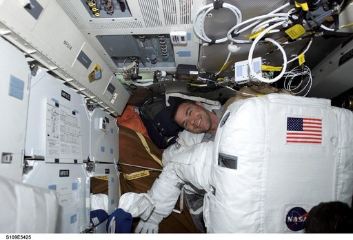 STS-109 PLT Carey helps prepares for EVA 4 on middeck