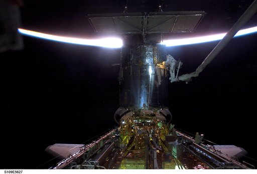 EVA 2 - MS Newman and Massimino on HST during sunrise