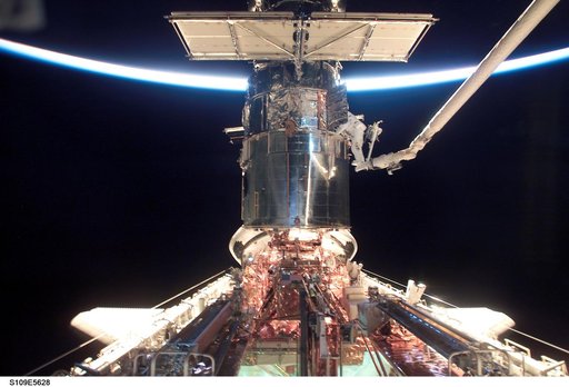 EVA 2 - MS Newman and Massimino on HST during sunrise