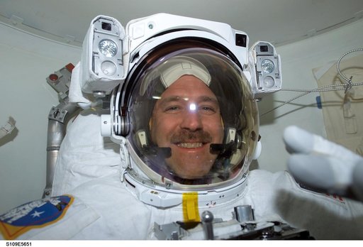 MS Grunsfeld  wearing EMU in airlock prepares for EVA 3
